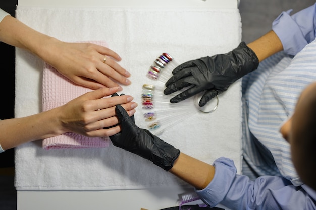 The process of manicure in a studio or beauty salon for women a manicure and pedicure master