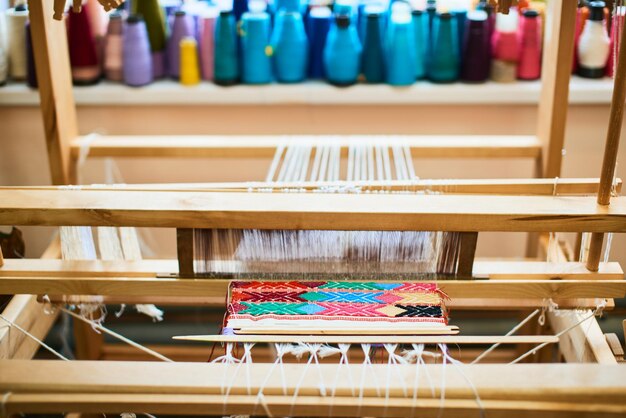 Photo the process of manufacturing textiles on a loom