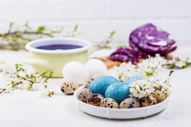 Process of painting Easter eggs in blue