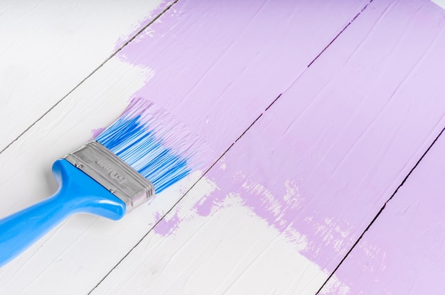 Process of painting the pine wood boards with the brush