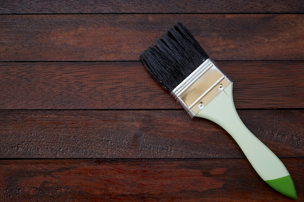 Process of painting wood surfaces with a brush