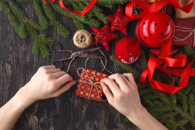 The process of preparing Christmas gifts. Kid hands