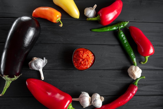 Photo the process of preparing the dish ajvar ingredients red pepper chili pepper garlic arranged in a cir