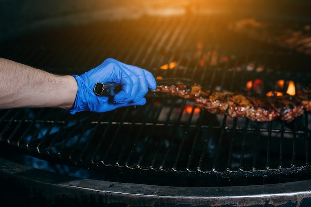 Process of preparing pork ribs on an open fire on grill