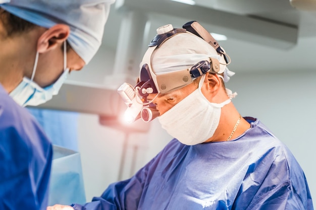 Process of surgery operation surgeons in operating room with\
surgery equipment medical background selective focus