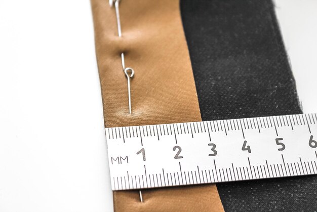 Photo processing of the seam with an oblique brown silk label close-up wrong side