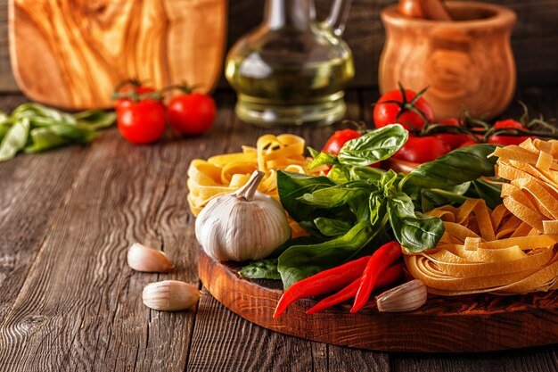 Producten om te koken - pasta, tomaten, knoflook, peper en basilicum.