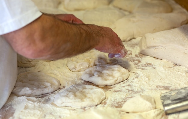 Production of baked bread with a wood oven in a bakery.