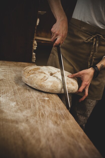 Production of baked bread with a wood oven in a bakery.