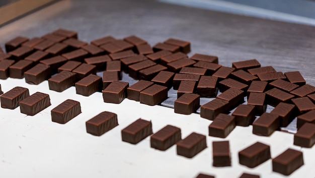 Production of chocolate candy Sweets on conveyor belt at factory