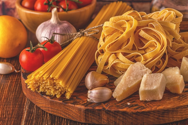 Products for cooking - pasta, tomatoes, garlic, olive oil and red wine