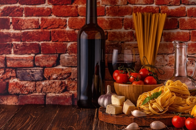 Products for cooking pasta, tomatoes, garlic, olive oil and red wine