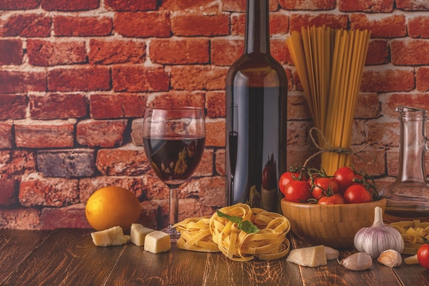 Products for cooking pasta, tomatoes, garlic, olive oil and red wine