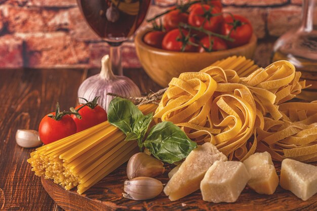 Products for cooking pasta, tomatoes, garlic, olive oil and red wine