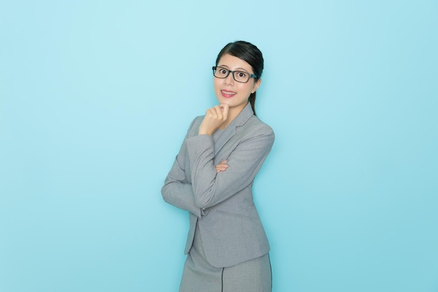 profession and industry job concept. attractive smiling female lawyer face to camera and showing empty area isolated on blue wall background.