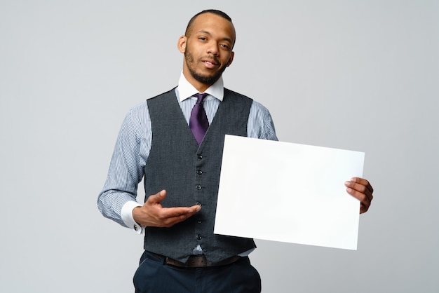 Professional African american business man and presenting holding blank sign
