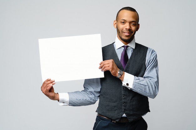 Professional African american business man and presenting holding blank sign