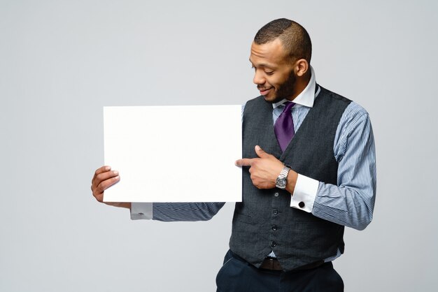 Professional African american business man and presenting holding blank sign