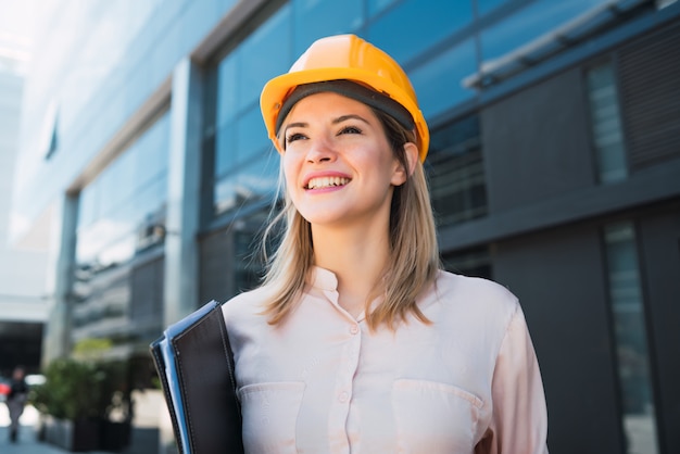 Professional architect woman standing outdoors.