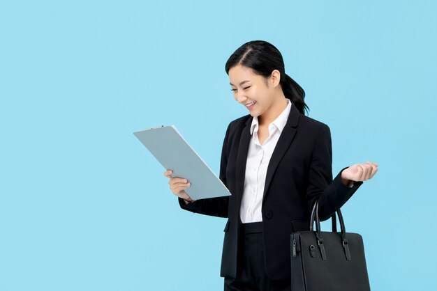 Photo professional asian businesswoman in formal suit looking at clipboard