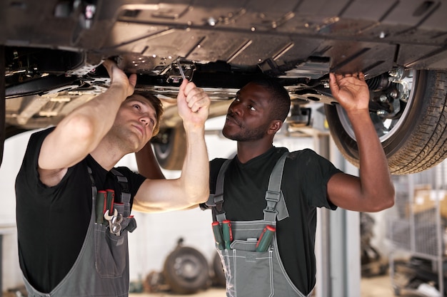 Professional auto mechanics repairing car