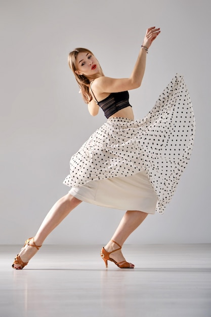 A professional ballroom dancer trains in a choreographic hall