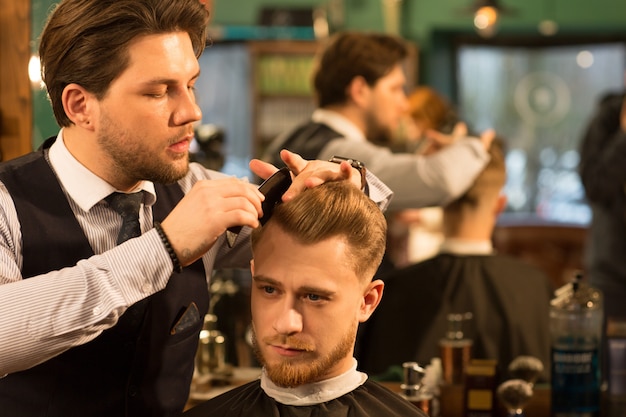 Professional barber working at his barbershop