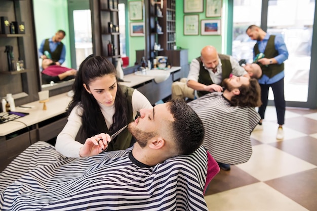 Professional barbers working in barbershop