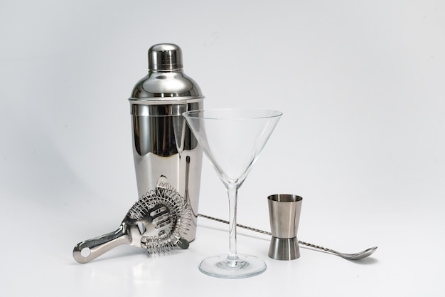 Professional bartender kit set cocktail shaker bar spoon hawthorne strainer on white background