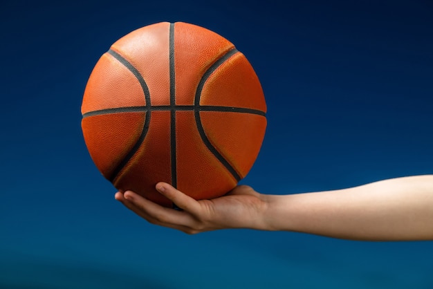 Professional basketball player holding a ball in the hand.