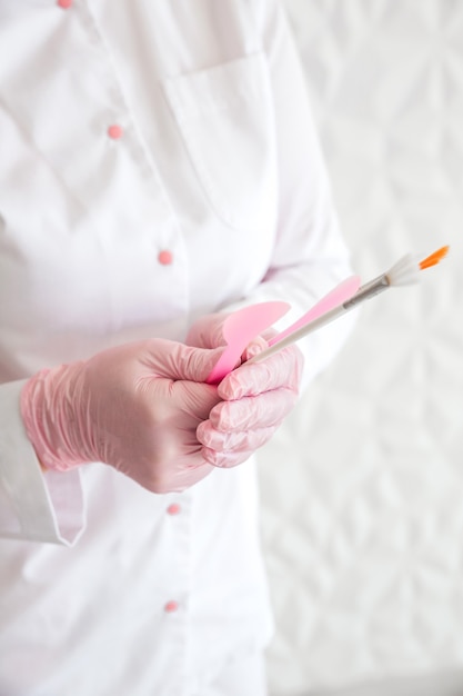 Professional beautician with brushes in hands. Woman beautician posing