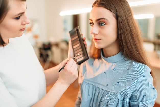 Professional beautician work with woman face