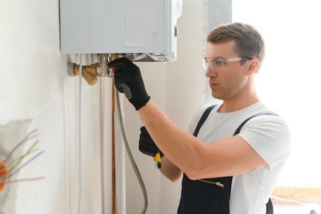 Professional boiler service qualified technician checking a natural gas boiler at home