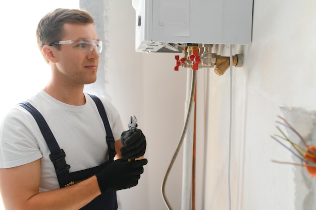 Professional boiler service qualified technician checking a natural gas boiler at home