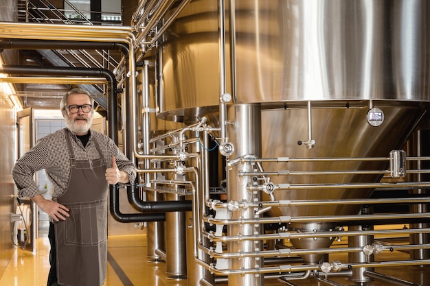Photo professional brewer on his own craft alcohol production