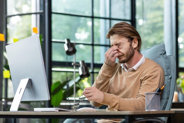 Professional burnout at work emotional breakdown overtime day tired young man programmer freelancer