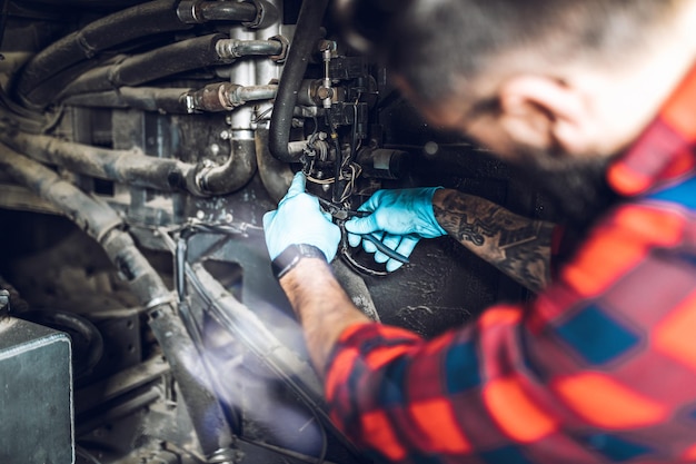 Professional bus mechanic working in vehicle repair service.