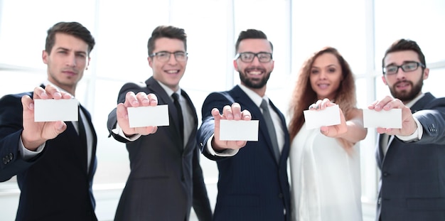 Professional business team showing their business cards