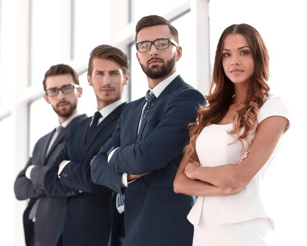 Professional business team standing in a bright office