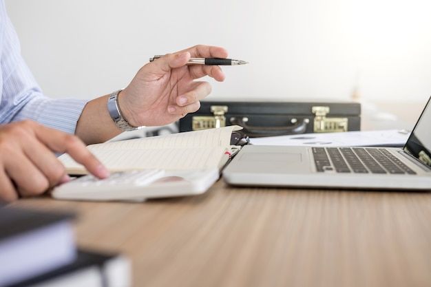 Professional businessman working at workplace with report, Doing finance on laptop