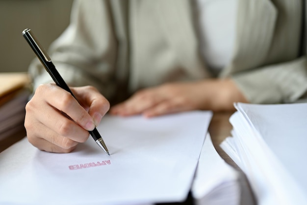 Professional businesswoman sign her signature to approve a business project