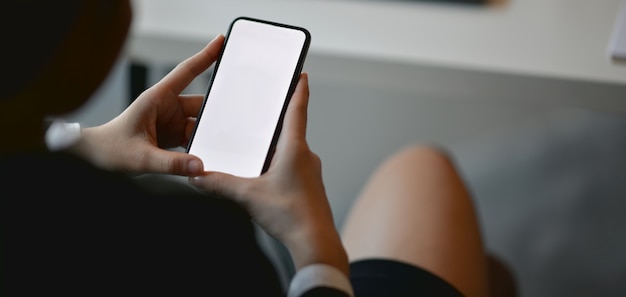 professional businesswoman working on her project while using blank screen smartphone