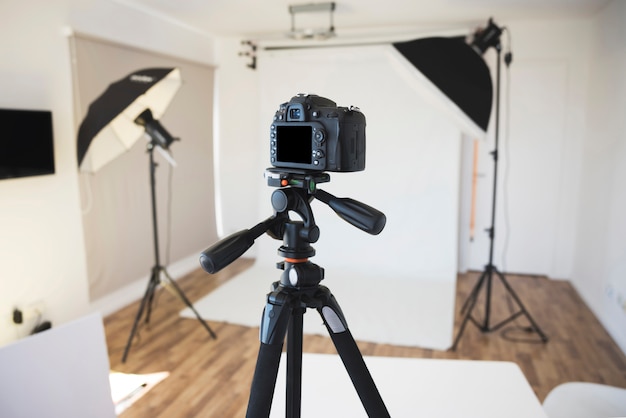 Professional camera on a tripod in modern photo studio