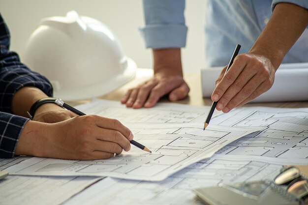 Professional cartographers working with cadastral map at table closeup