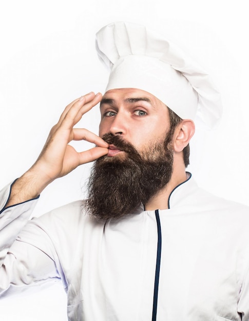 Professional chef man showing sign for delicious. Chef, cook making tasty delicious gesture by kissing fingers.