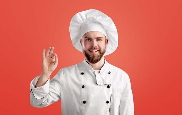 Professional chef man showing sign for delicious. male chef in white uniform with perfect sign