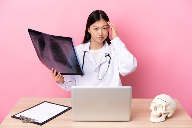 Professional Chinese traumatologist in workplace unhappy and frustrated