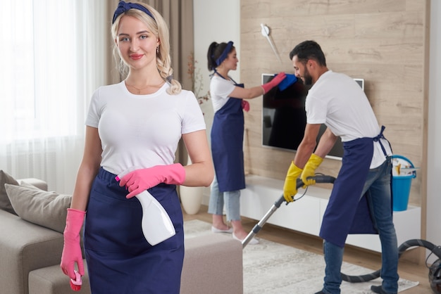 Close-up of housekeeper holding modern washing vacuum cleaner and