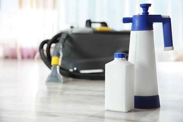 Professional cleaning supplies and equipment on floor indoors Space for text