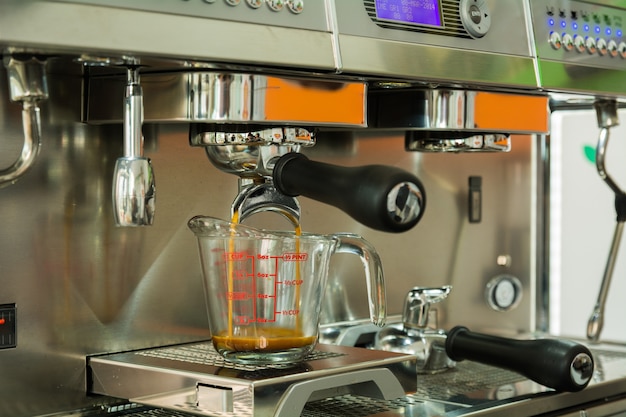 Professional coffee machine making espresso in a cafe